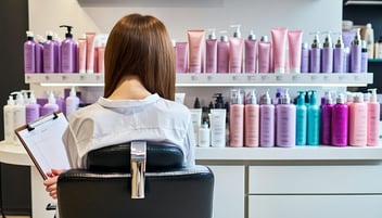 A woman sitting in a chair at a hair salon