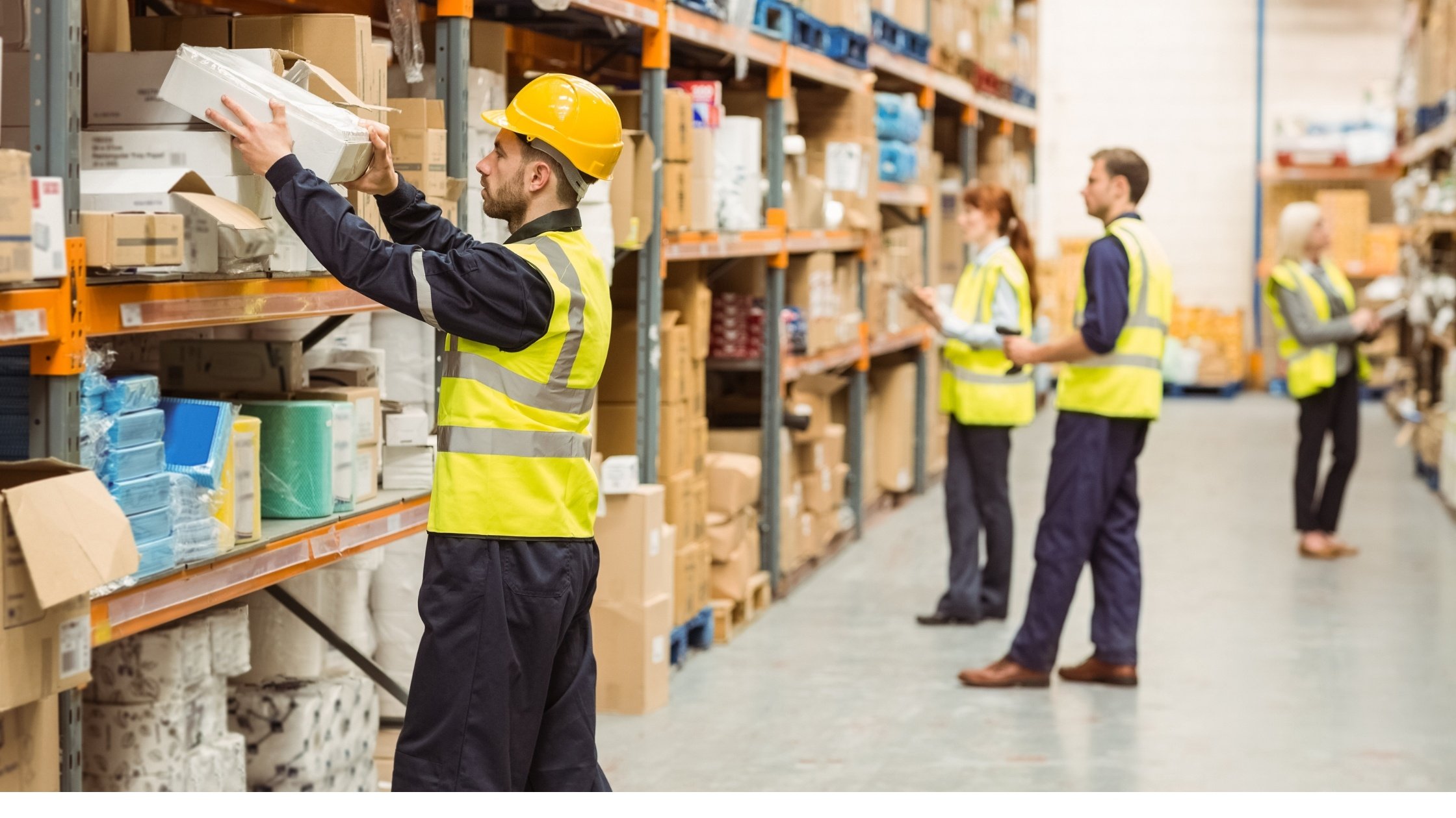  warehouse workers taking inventory of stock 