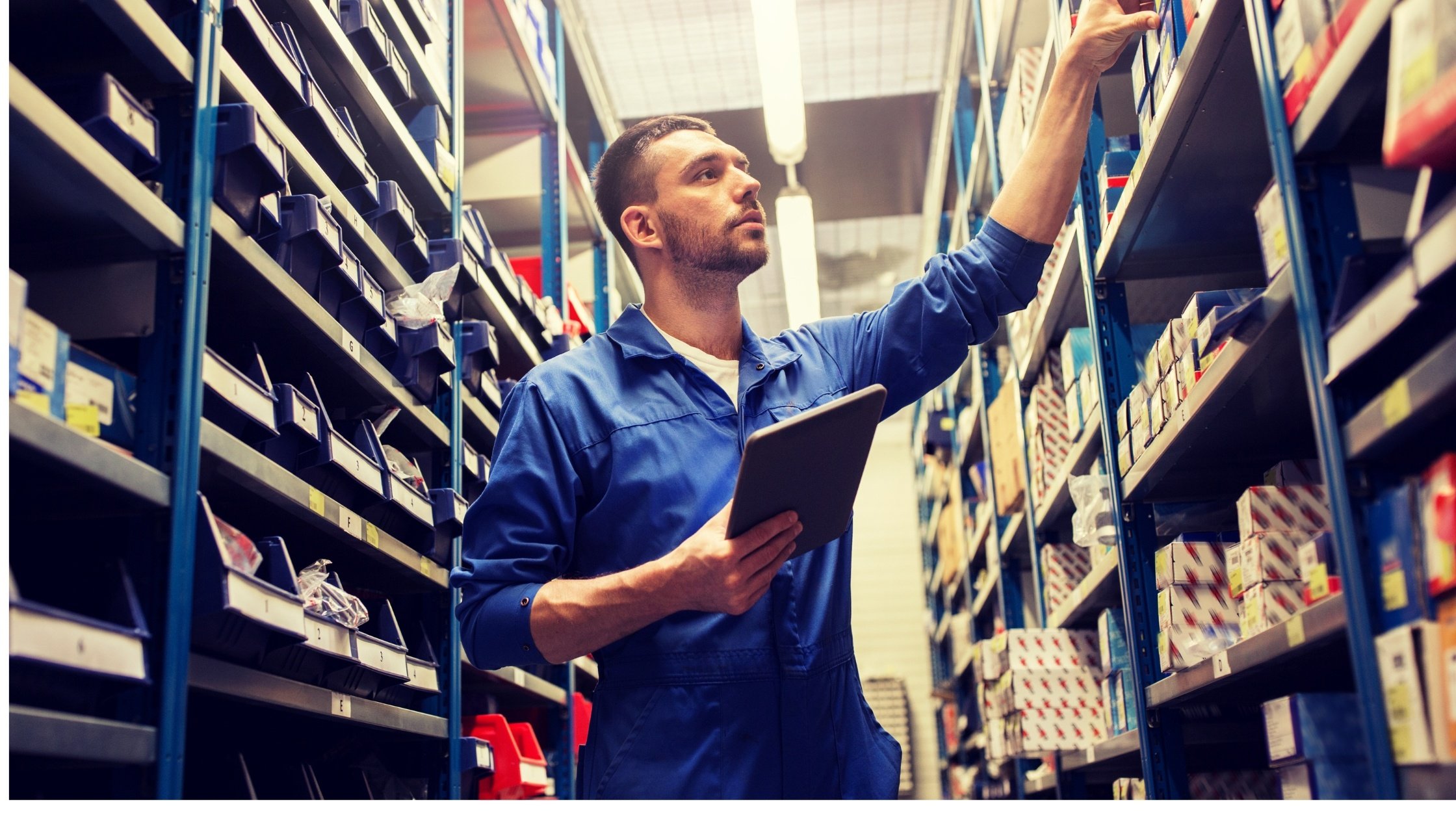  A person with a tablet looking at stock in a warehouse 