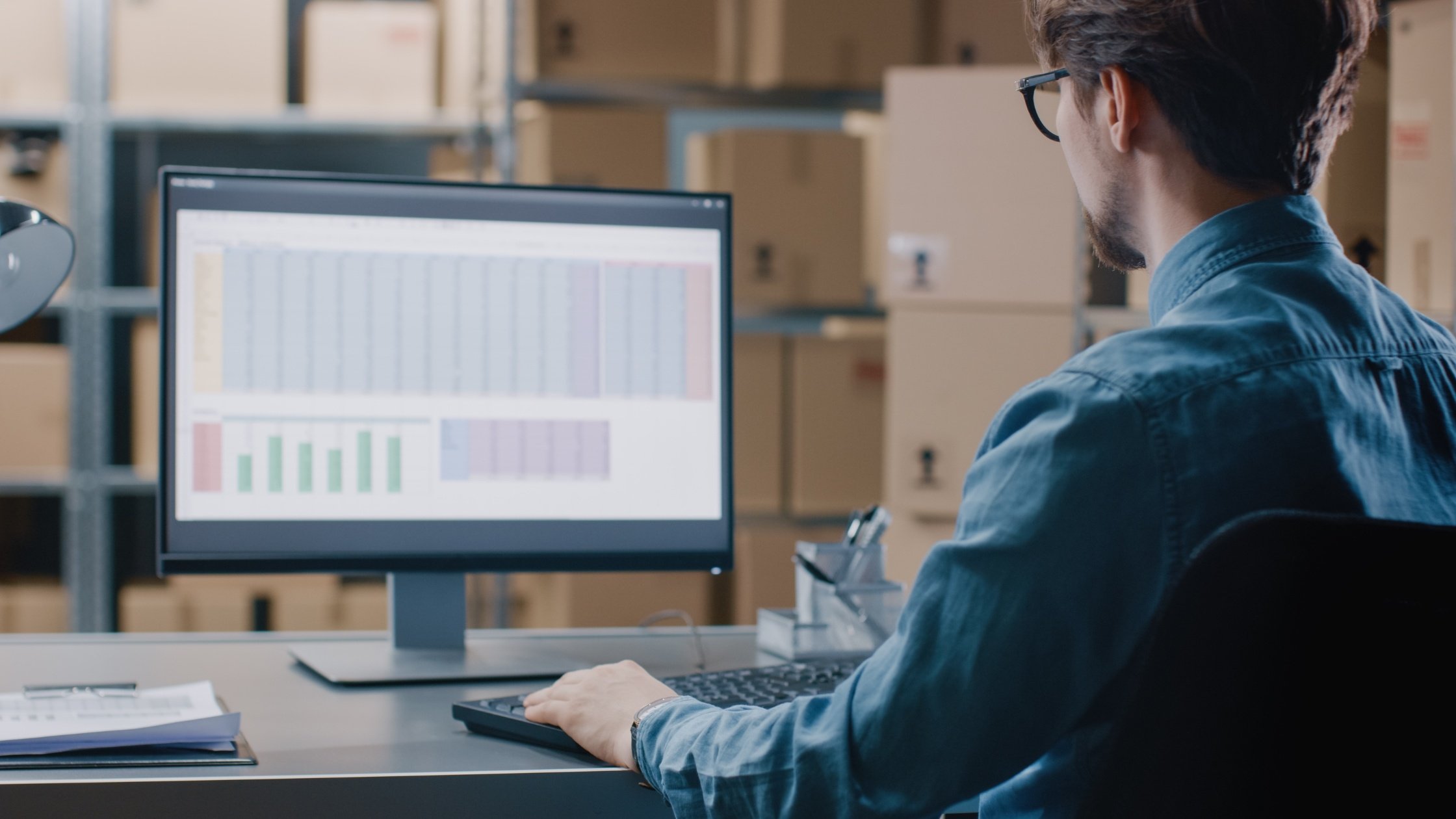  Person sitting at a computer looking at charts 